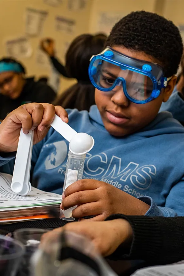 Freire Middle student doing a science experiment